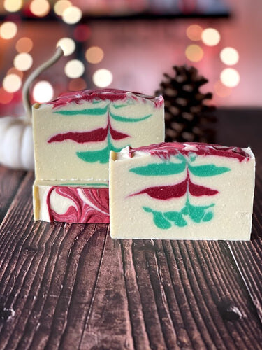 Six handmade soap bars lined in a row at a 45 degree angle to the right.  The soaps are naturally colored with clays and botanicals, and handmade using the cold process method, in small batches.  The workshop is based in Washington, DC.